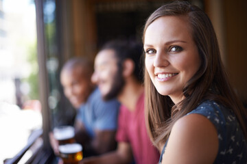 Portrait, happy and a woman at pub to relax, cheerful or positive facial expression for leisure at restaurant tavern. Face, bar and smile of young female person or casual customer at cafe for alcohol - obrazy, fototapety, plakaty