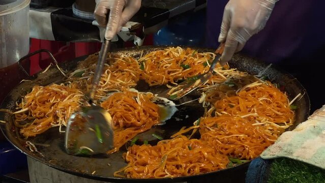 chef making Thai food ( pad Thai) at street market in thailand.