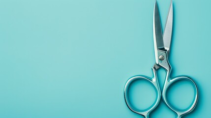 A pair of silver scissors on a blue background. The scissors are open and the blades are facing upwards. The handles are blue and have a shiny finish. - obrazy, fototapety, plakaty