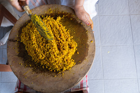 Raw Spices or in Balinese called Bumbu Megenep Being Chopped on a Wooden coaster with Blakas or Belakas, a Traditional Sharp Weapon from Bali