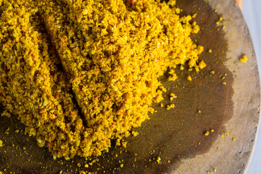 Raw Spices or in Balinese called Bumbu Megenep Being Chopped on a Wooden coaster with Blakas or Belakas, a Traditional Sharp Weapon from Bali