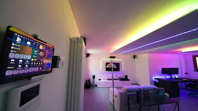 A modern basement room with led lighting coming from plasterboard structures on the ceiling