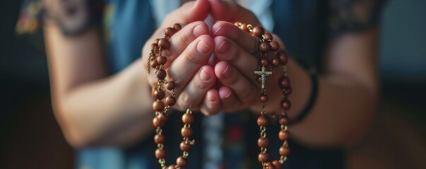 Woman hands holding a rosary and praying