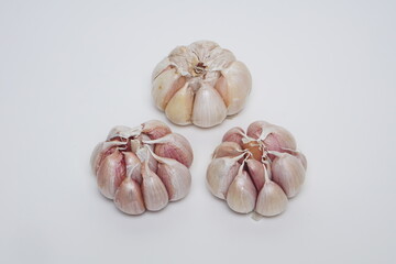 several cloves of garlic at flat lay on a white background