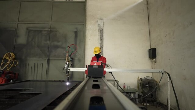 Worker with CNC machine. professional worker cutting iron plates. worker cutting iron sheets with a plasma cutter