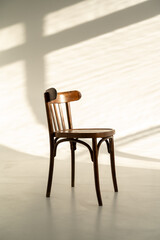 Old wooden chair in the interior of a photo studio with sunlight