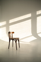 Old wooden chair in the interior of a photo studio with sunlight