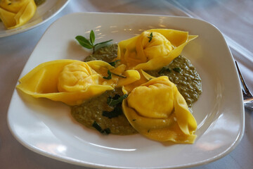 Close up Burrata Tortelloni Pasta served with pea Pesto sauce
