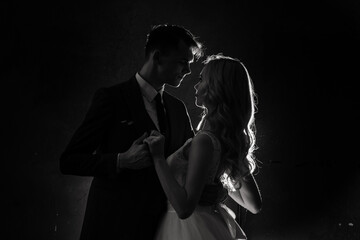 Art fashion studio photo of wedding couple silhouette groom and bride on colors background.