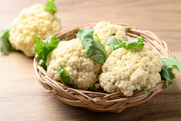 Organic cauliflower in basket on wooden background, Healthy vegetables for food ingredient