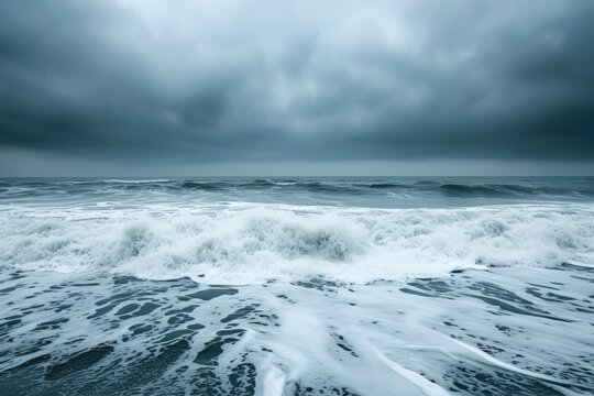 A photo capturing a sprawling expanse of water beneath a cloudy sky, highlighting the interaction between the two elements, Stormy ocean waves under a graying sky, AI Generated