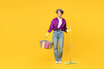 Full body young fun woman wear purple shirt casual clothes do housework tidy up hold in hand mop...
