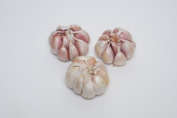 several cloves of garlic at flat lay on a white background