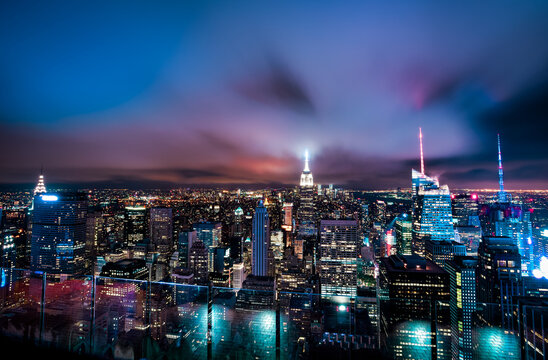 Beautiful View from Top of the Rock to the Empire State and Manhattan Skyline on a Cloudy Night - New York City, USA