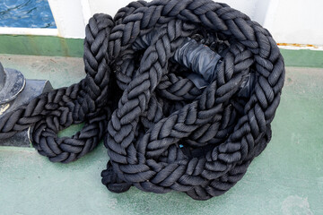 Black braided mooring cable on the deck of the ferry