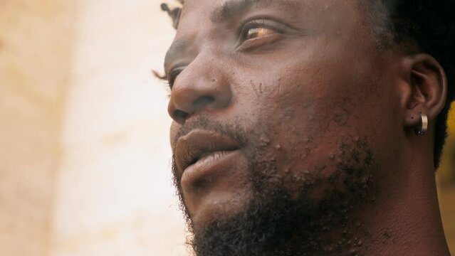 portrait of young african man on the street discouraged by life's adversities