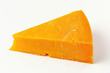 A wedge of aged cheddar on a stark white background