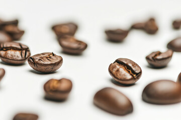 Obraz premium A scatter of roasted coffee beans on a white background