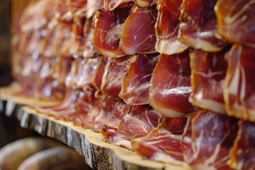 Foto auf Acrylglas A variety of meat products arranged on top of a wooden shelf, Traditional Spanish Iberico ham beautifully displayed, AI Generated © Iftikhar alam