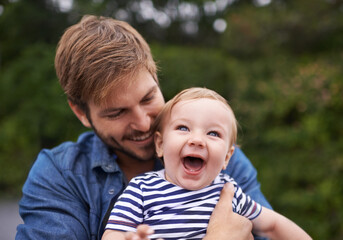 Fototapeta na wymiar Father, laughing and baby in park to hug for playing, happiness and bonding in a family in nature. Relax, boy or face of a toddler with dad, love or smile for child development, wellness or growth