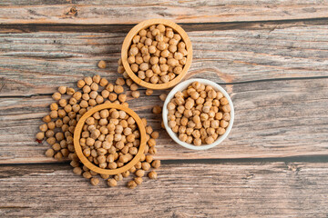 Chickpeas source and peeled barley in a basket wooden isolated on wood background
