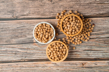 Obraz na płótnie Canvas Chickpeas source and peeled barley in a basket wooden isolated on wood background 