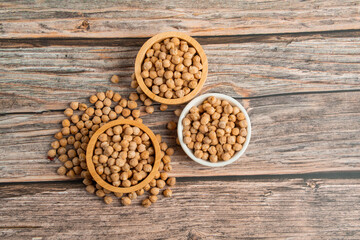Chickpeas source and peeled barley in a basket wooden isolated on wood background
