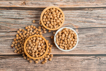 Chickpeas source and peeled barley in a basket wooden isolated on wood background
