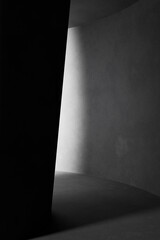 A black and white background with light coming through the building structure.