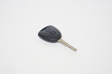 The shutter key and remote type car key is black with plastic and iron on a white background