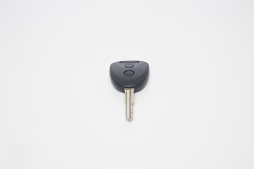 The shutter key and remote type car key is black with plastic and iron on a white background