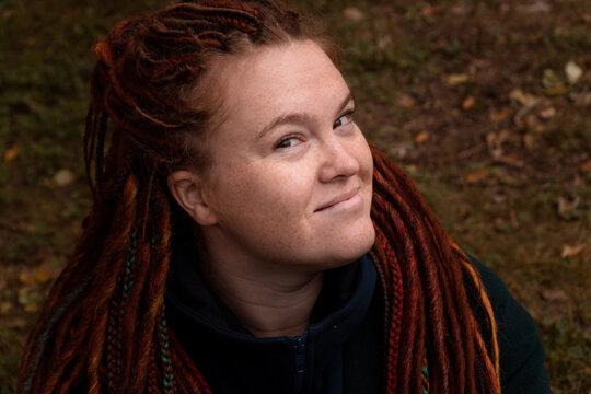 face of happy adult redhead body positive woman with dreadlocks