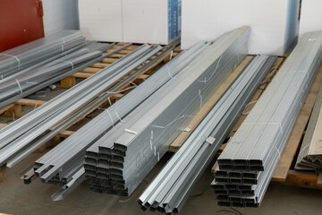 Metal profile pipe of rectangular cross section in packs at the warehouse of metal products.