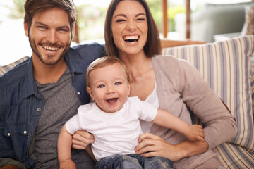 Laughing, happy family or portrait of baby on sofa in home for support, security or bonding in...