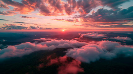Aerial view of a breathtaking sunset over mountains, with clouds and warm skies, from a pilot's perspective.	