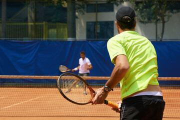 Fitness, health and tennis with man on court for competition, game or match in summer from back....