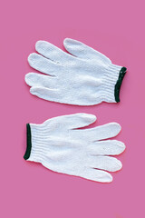 White cotton gloves on pink background.
