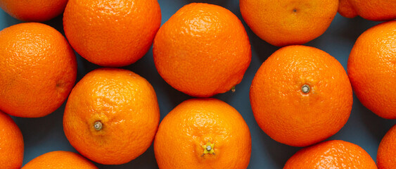 Many fresh oranges top view banner. Vibrant photo of citrus fruits flat lay background. Vitamin C