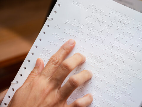 Braille Alphabet with hand Reading book document for Blind People 