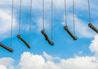 rope ladder against a blue sky and clouds