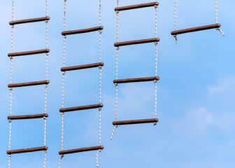 rope ladder against a blue sky and clouds