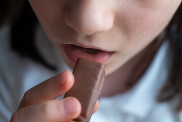 Child Eating Chocolate Candy: Close-Up