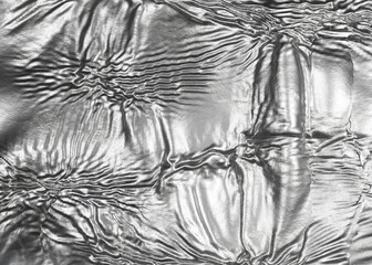 Wrinkled sheet of crushed tin aluminum silver foil