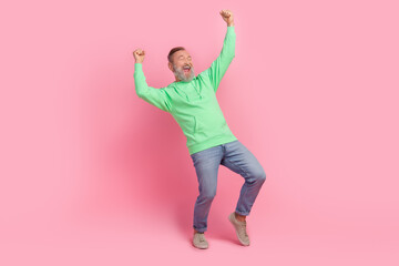 Full size photo of cool pensioner man raise fists winning lottery dressed stylish green clothes isolated on pink color background