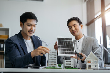 Asian business people using tablet for working technology and business, Renewable energy-based...