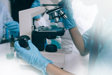 Science and medicine, scientist analyzing and dropping a sample into a glassware, experiments containing chemical liquid in laboratory on glassware, innovative and technology.
