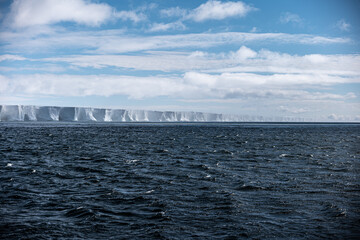 Antarctic ice shelf and stormy sea © David