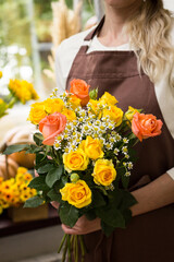 Florist holding a bouquet in a flower shop