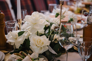 Flowers decor on table. Wedding set up, dinner table reception in a restaurant. Food and drink on dining table. Serving, setting table in hall.  Glass, luxury rich decor. Birthday, baptism, event.