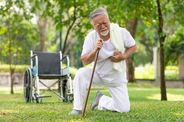 asian senior man suffering and having chest pain from heart attack in the park